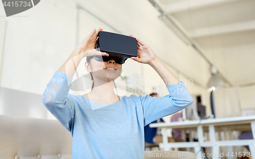 Image of happy woman with virtual reality headset at office