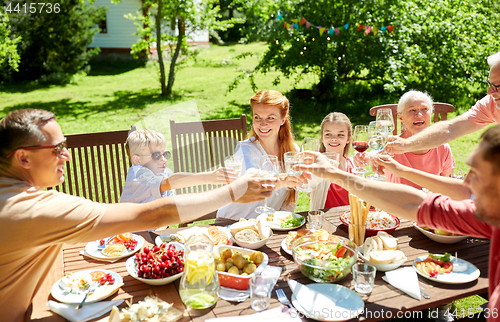 Image of happy family having dinner or summer garden party