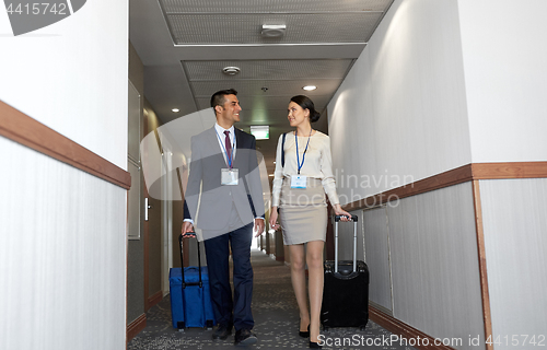 Image of business team with travel bags at hotel corridor