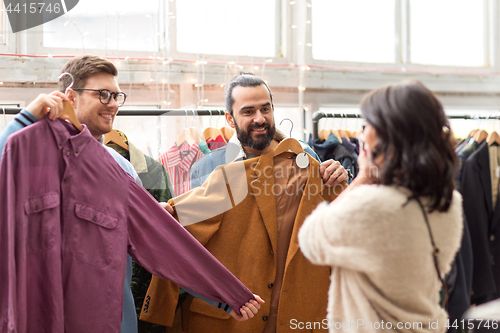 Image of friends photographing at vintage clothing store