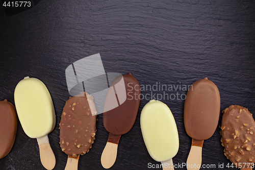 Image of Ice cream on stick covered with chocolate 