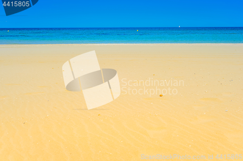 Image of European sandy beach and blue sea.