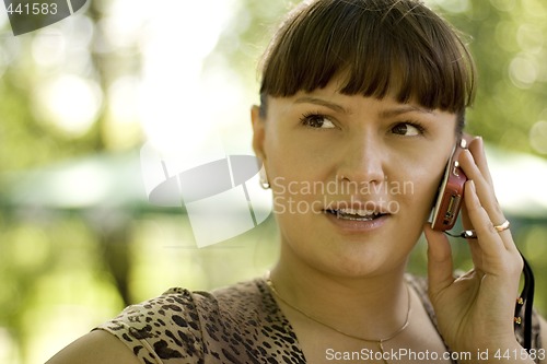 Image of beautiful woman calling by phone