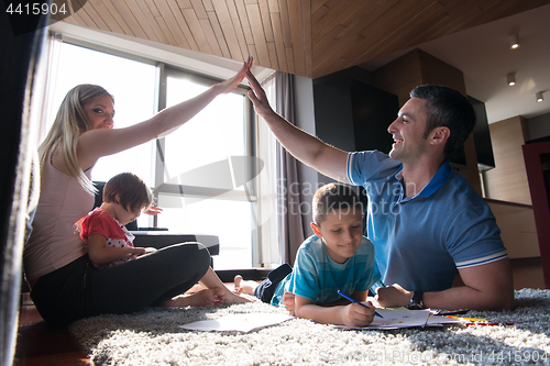 Image of young couple spending time with kids