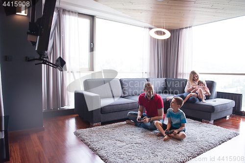 Image of Happy family playing a video game