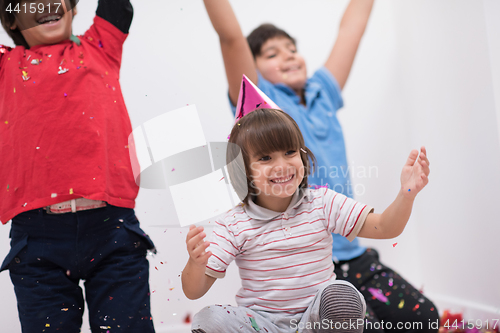 Image of kids  blowing confetti