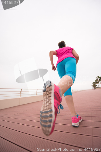 Image of woman busy running on the promenade