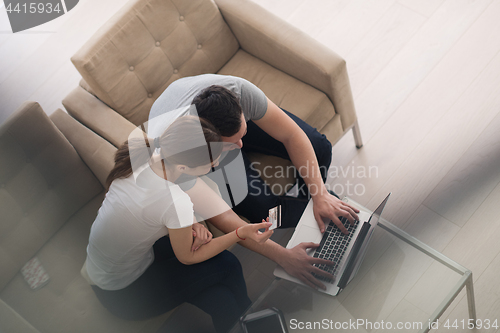 Image of happy young couple buying online