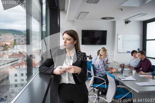 Image of Business Girl Standing In A Modern Building Near The Window With