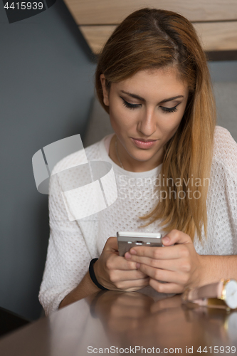 Image of young woman using mobile phone