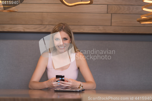 Image of young woman using mobile phone