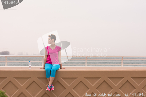 Image of young woman sitting after a successful training run