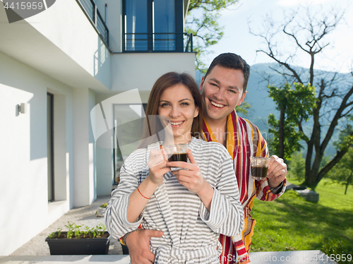 Image of Young beautiful couple in bathrobes