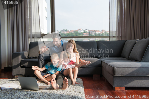 Image of Family Playing Together with laptop computer