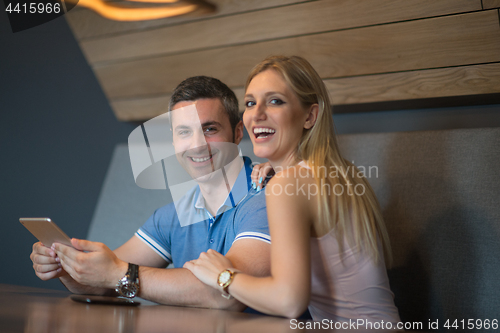 Image of couple using tablet at home