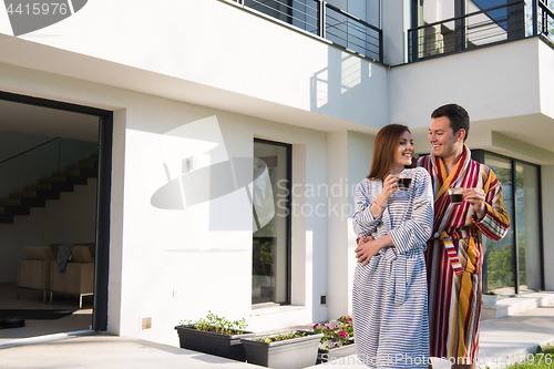 Image of Young beautiful couple in bathrobes