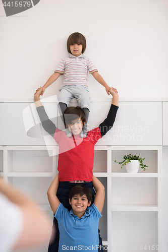 Image of young boys posing line up piggyback