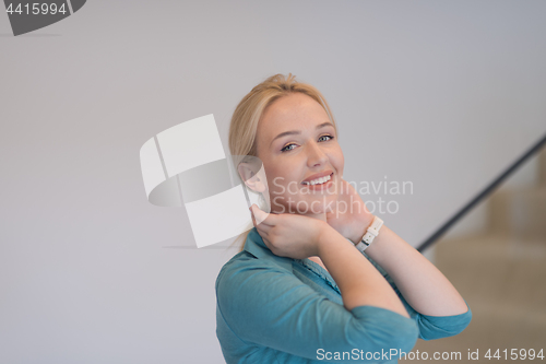 Image of portrait of a young beautiful woman on the stairs