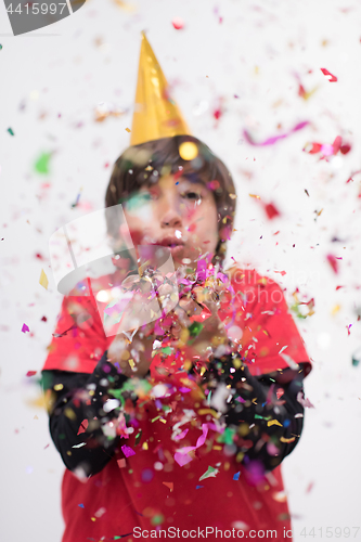 Image of kid blowing confetti