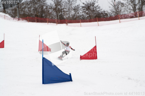 Image of Blurred view of snowboarding giant slalom competitions