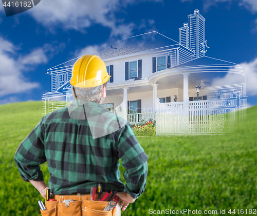 Image of Contractor Standing Outdoors Looking Over Grass Site with Ghoste