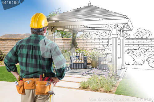 Image of Contractor Standing Looking At Patio Pergola Design Drawing and 