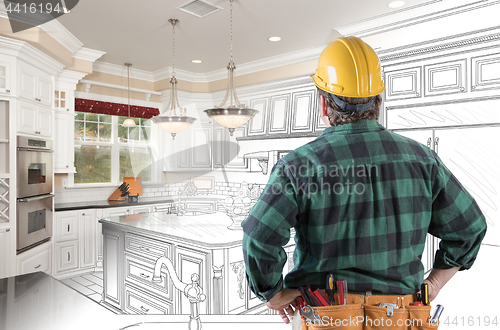 Image of Male Contractor with Hard Hat and Tool Belt Looking At Custom Ki