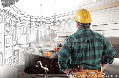 Image of Male Contractor with Hard Hat and Tool Belt Looking At Custom Ki