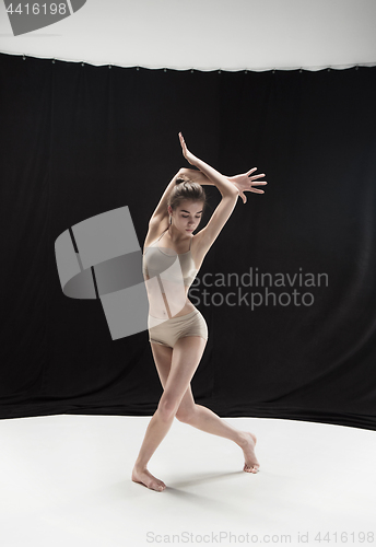 Image of Young teen dancer on white floor background.