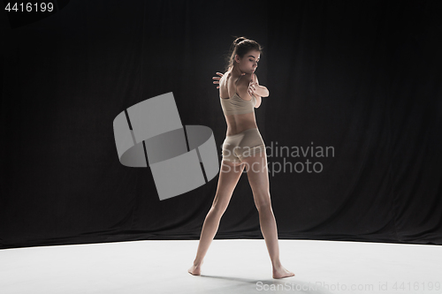 Image of Young teen dancer on white floor background.