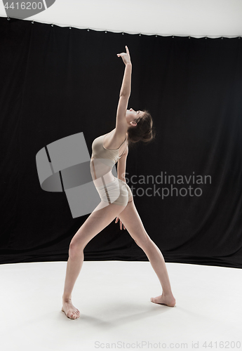 Image of Young teen dancer on white floor background.