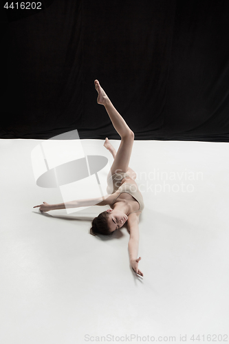 Image of Young teen dancer on white floor background.