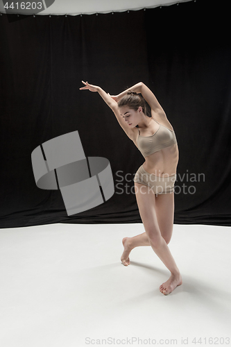 Image of Young teen dancer on white floor background.