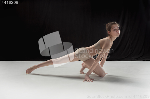 Image of Young teen dancer on white floor background.