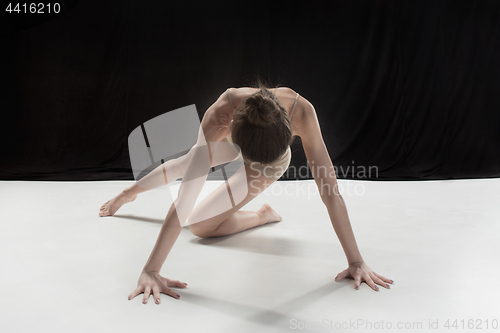Image of Young teen dancer on white floor background.