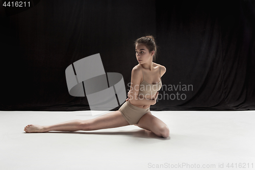 Image of Young teen dancer on white floor background.