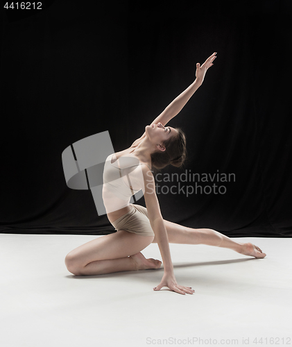 Image of Young teen dancer on white floor background.