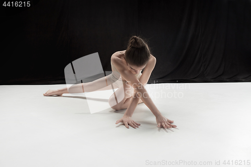 Image of Young teen dancer on white floor background.