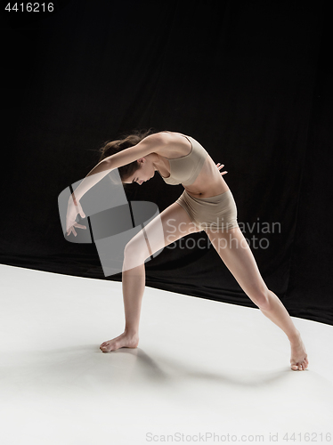 Image of Young teen dancer on white floor background.