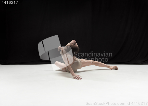 Image of Young teen dancer on white floor background.