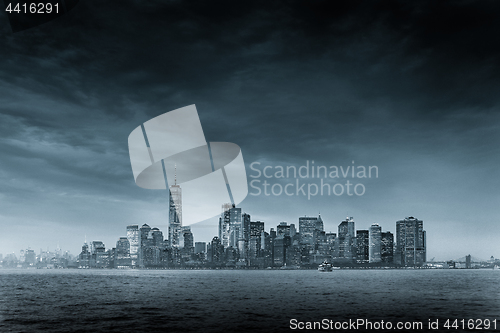 Image of Panoramic view of storm over Lower Manhattan from Ellis Island at dusk, New York City.