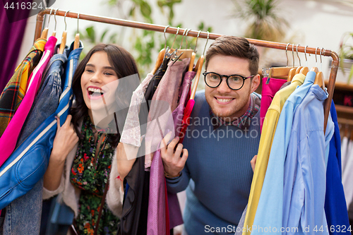 Image of happy couple having fun at vintage clothing store
