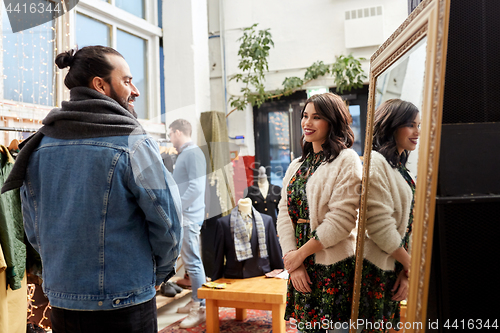 Image of couple choosing clothes at vintage clothing store