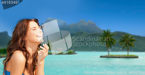 Image of happy woman enjoying sun on bora bora beach