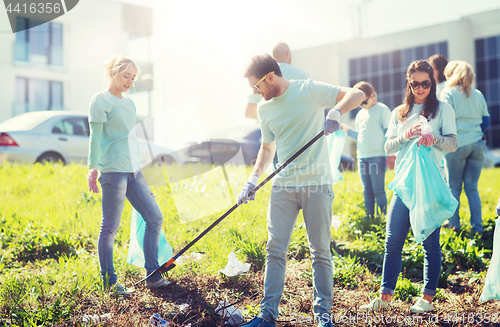 Image of volunteers with garbage bags cleaning park area