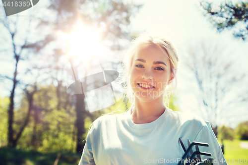 Image of happy young volunteer woman outdoors