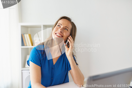 Image of woman calling on smartphone at office or home
