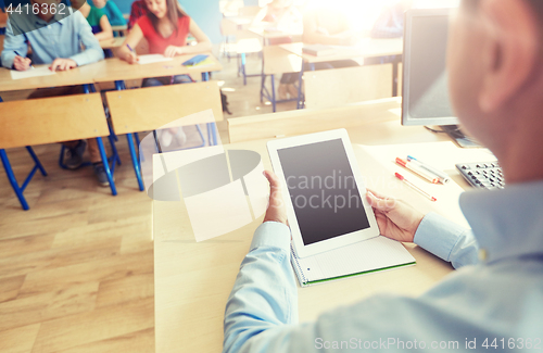 Image of students and teacher with tablet pc at school