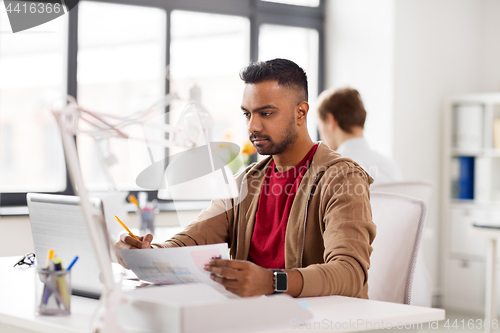 Image of indian man with laptop computer at office