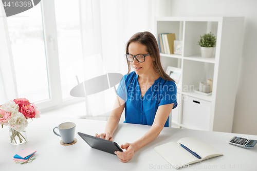 Image of woman with tablet pc and coffee at home or office